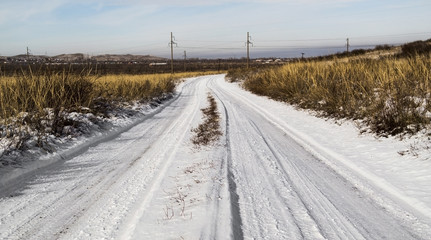 Snow road in the steppe. Winter steppe background. Steppe landscape