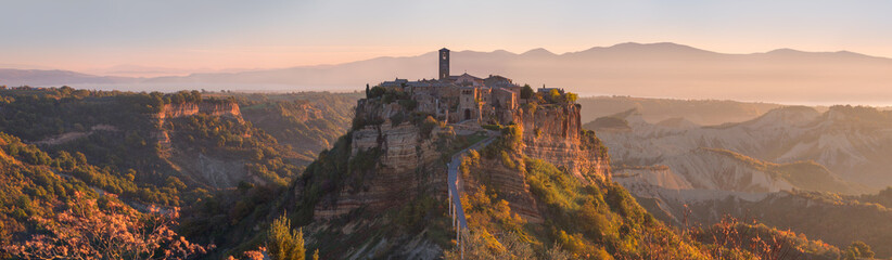 Beautiful panoramic view of famous Civita di Bagnoregio with Tiber river valley at sunset, Lazio, Italy - obrazy, fototapety, plakaty