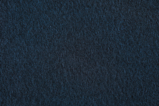 Texture of the sintepon. Dark brown background.