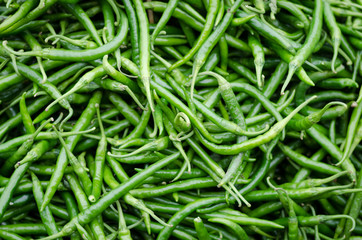 Green pepper or chili from the farm, Close up or macro fresh beautiful Green peppers on the market texture and background, a lot of chili on basket for trader and business and establishment