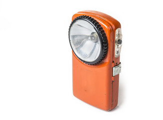 Old battery flashlight on the white background