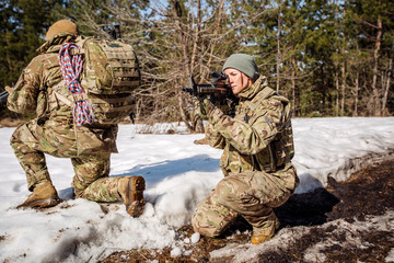Fototapeta premium team of special forces weapons in cold forest. Winter warfare and military concept