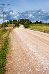 Gravel road in cloudy day.