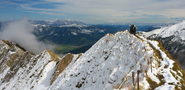 Group of tourists on the mountain ridge nearby ski resort Kaprun, Austria