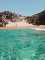 Golden sand and emerald water of Papagayo Beach from ocean water in Lanzarote, Canary Islands