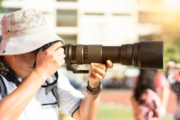 Fototapeta premium Photographer shooting soccer game and player in stadium.