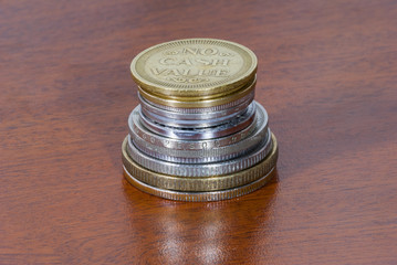 Group of coins without value on wood texture.