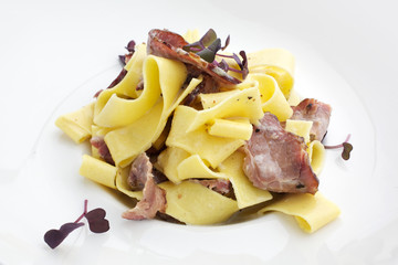 Pasta carbonara with bacon on white background