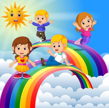 Happy kids standing over the rainbow