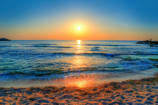 Fototapeta Beautiful background with colorful sunrise over the sea in Costinesti beach, Constanta - Romania