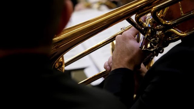 Footage of a person playing on a trombone...