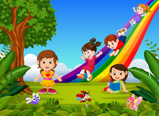 Obraz na płótnie Canvas Cartoon kids sliding down the rainbow