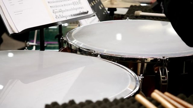 Close up footage of a musician playing on the kettledrum...