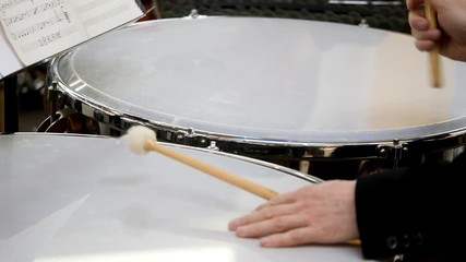 Close up footage of a person playing on the kettledrum