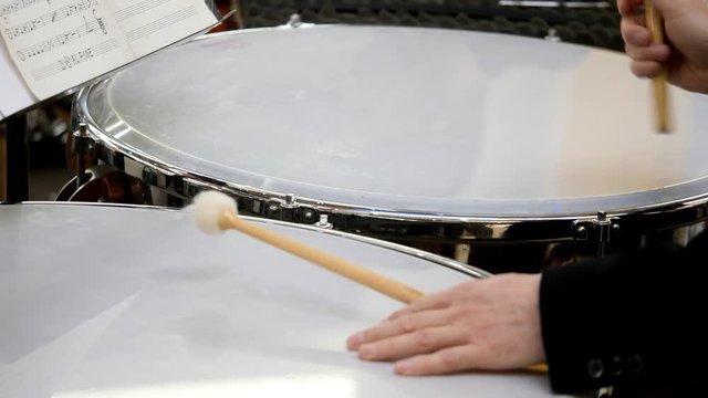 Close up footage of a person playing on the kettledrum