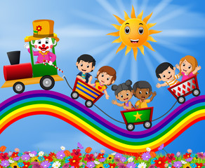 Obraz na płótnie Canvas Clown and childrens travelling train on the rainbow