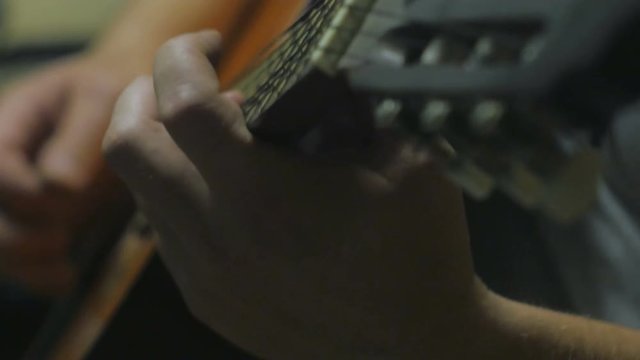 Dynamic 4k shot of the musician playing the guitar