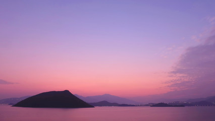 Naklejka na ściany i meble small island, mountain and sea at sunset