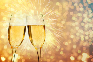 Champagne glasses on sparkling background