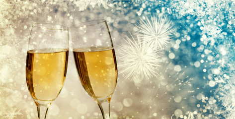 Champagne glasses on sparkling background