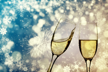 Champagne glasses on sparkling background