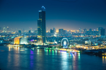 Fototapeta na wymiar Bangkok river side cityscape. Bangkok night view in the business district. at twilight.Panorama view of Bangkok city scape at night time. vintage colour tone