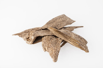 Agarwood, also called aloeswood incense chips from Thailand, isolated on white