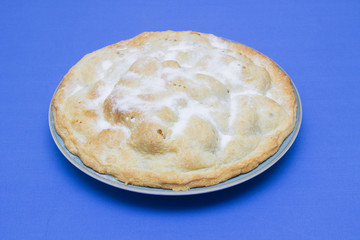 A traditional homemade apple pie made with bramley apples and sprinkled with caster sugar