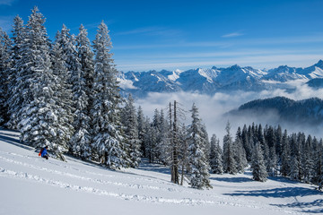 Skitouring in the Allgaeu Alps near Oberstdorf on a beautiful bluebird day in winter