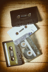 Old cassette tapes with a wooden background