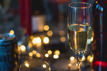 candles and wine on table with bokeh