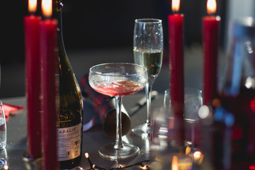 candles and wine on table with bokeh