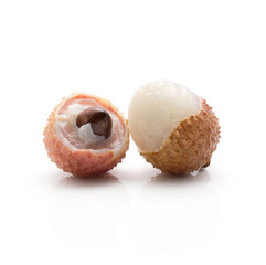 Two peel lychee one with brown seed isolated on white background ripe pink fresh berries.