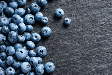 Deluxe blueberry on black slate. Copy space. Top view. High resolution product.