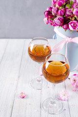 Buds of red roses and glases of wine
