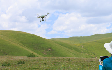 woman photographer flying drone outdoors