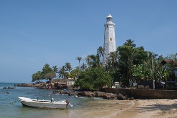 Lighthouse in Dondra and fishing boats at the southernmost point of Sri Lanka, which was built in 1889.
