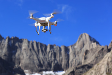 flying drone in the air over high altitude mountains