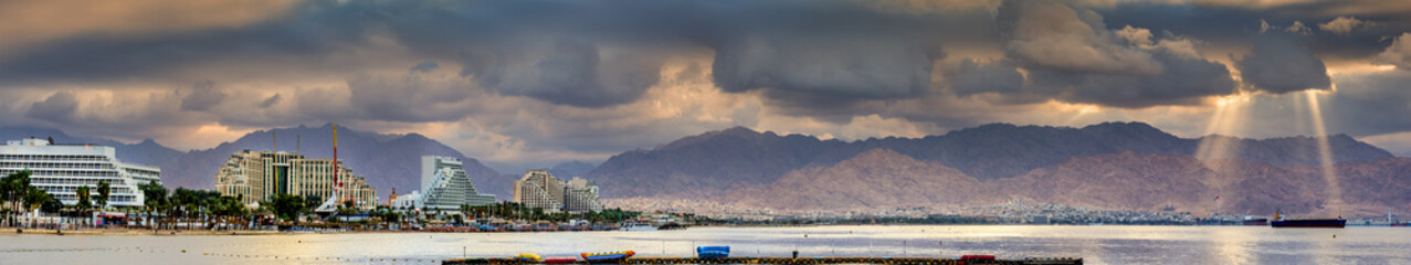 Panoramic view on the central public beach of Eilat city and northern shore of the Red Sea 