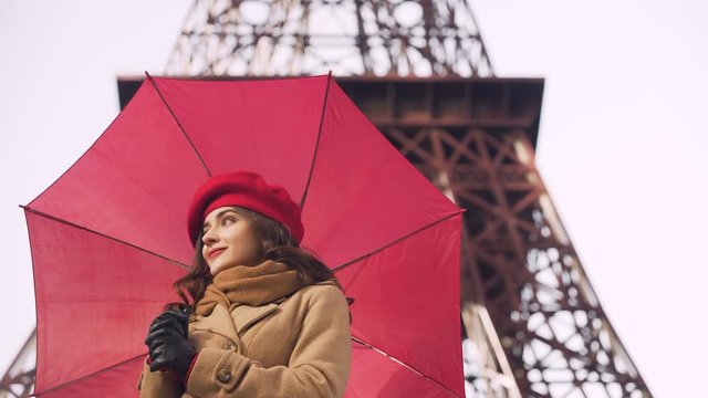 Beautiful girl looking forward to her boyfriend, rainy day, date in Paris