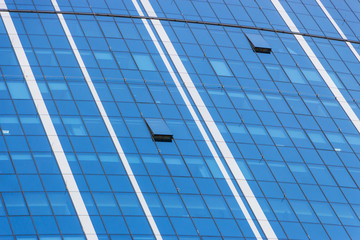 Fototapeta na wymiar Clouds Reflected in Windows of Modern Office Building