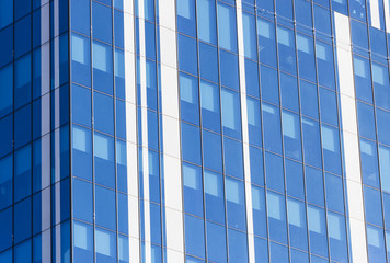 Obraz premium Clouds Reflected in Windows of Modern Office Building