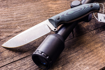 Hunting composition. Hunting knife and optical sight.