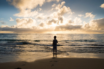 Fototapeta na wymiar Child Playing on Beach in Oahu Hawaii