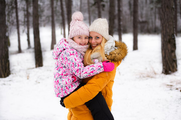 Happy family mother and child on winter