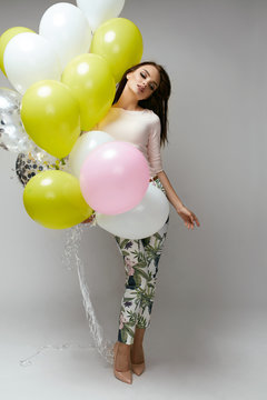 Beautiful Woman With Balloons In Fashion Clothes