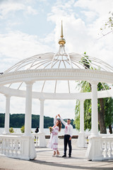 Happy newly married couple dancing in the gazebo on their wedding day.