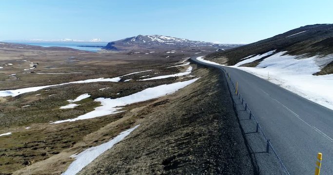 Flying backwards along Rte 85 over desolate landscape near Vidarfjall in Northeast Iceland