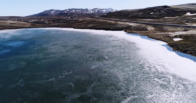 Flying over a small isolated lake near Vidarfjall in Northeast Iceland