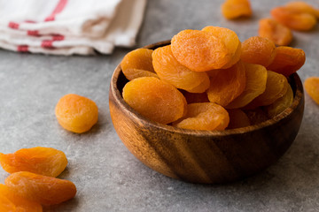 Dried Apricots in wooden Bowl.